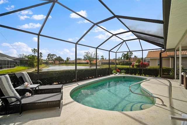 outdoor pool with a lanai, a water view, and a patio