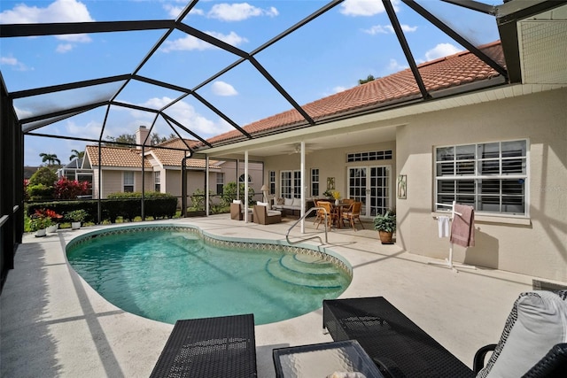 pool with a ceiling fan, a lanai, a patio, and an outdoor hangout area