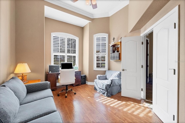 home office featuring ornamental molding, ceiling fan, baseboards, and wood finished floors