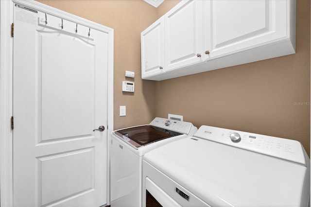 laundry room with cabinet space and washing machine and clothes dryer