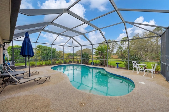 outdoor pool with glass enclosure and a patio