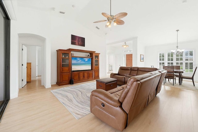 6211 90th Avenue Cir E, Parrish, FL 34219 - living room featuring light wood-type flooring, a chandelier, a ceiling fan, and high vaulted ceiling