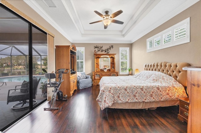 6211 90th Avenue Cir E, Parrish, FL 34219 - bedroom featuring dark wood-style flooring, a tray ceiling, ornamental molding, access to outside, and ceiling fan