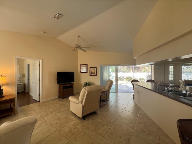 living area featuring a wealth of natural light, visible vents, and light tile patterned floors