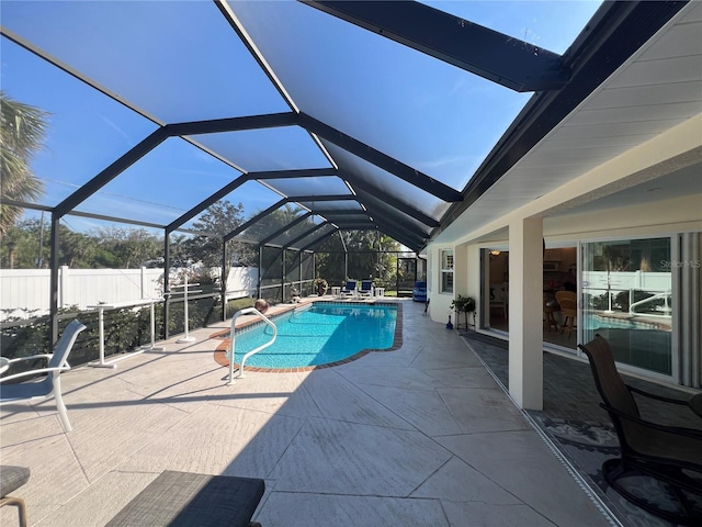 view of pool with glass enclosure, a patio area, fence, and a fenced in pool