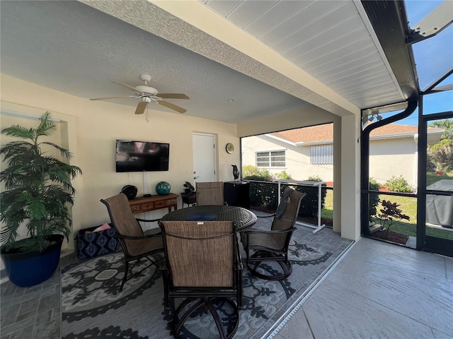 sunroom / solarium with a ceiling fan