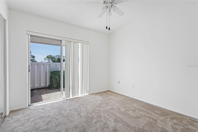 carpeted spare room with ceiling fan, a textured ceiling, and baseboards