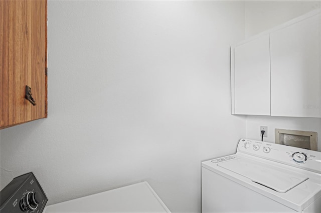 washroom featuring cabinet space and washer / clothes dryer