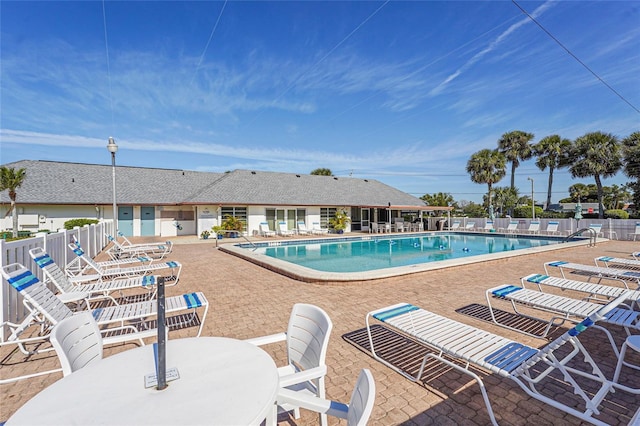 community pool featuring a patio area and fence