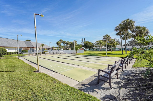 view of community featuring shuffleboard, a lawn, and a residential view