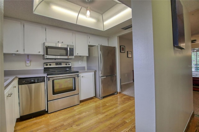 3658 Lake Bayshore Dr Unit 320, Bradenton, FL 34205 - kitchen featuring stainless steel appliances, visible vents, white cabinets, light countertops, and light wood-type flooring