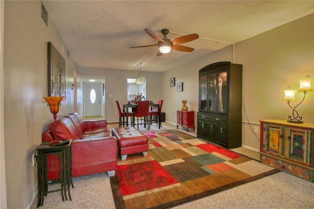 3658 Lake Bayshore Dr Unit 320, Bradenton, FL 34205 - carpeted living area featuring a textured ceiling, baseboards, visible vents, and a ceiling fan