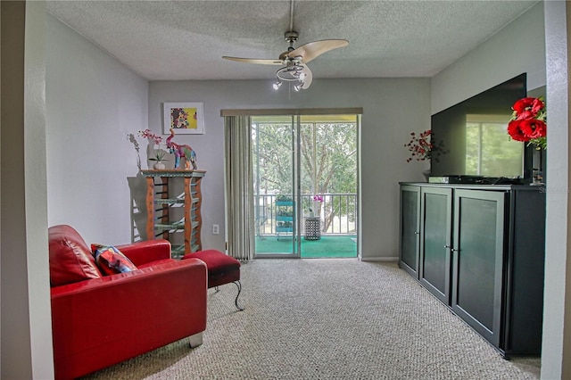 3658 Lake Bayshore Dr Unit 320, Bradenton, FL 34205 - sitting room featuring carpet, a textured ceiling, and a ceiling fan