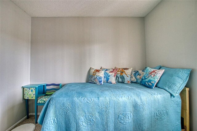 3658 Lake Bayshore Dr Unit 320, Bradenton, FL 34205 - carpeted bedroom with a textured ceiling and baseboards