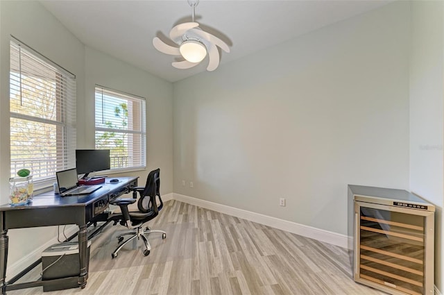 5591 Cannes Cir Unit 403, Sarasota, FL 34231 - office area with beverage cooler, light wood-style flooring, baseboards, and a ceiling fan