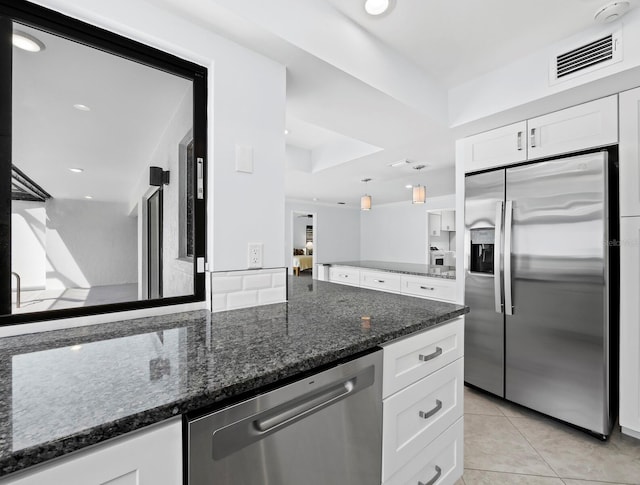 kitchen featuring a peninsula, white cabinetry, visible vents, and appliances with stainless steel finishes