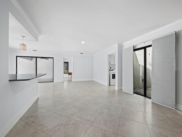 empty room featuring crown molding, light tile patterned floors, recessed lighting, washer / clothes dryer, and baseboards