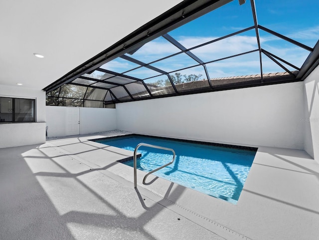 view of swimming pool featuring a patio area, glass enclosure, and a fenced in pool