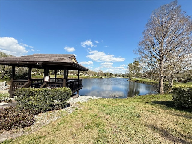 dock area with a water view, a yard, and a gazebo