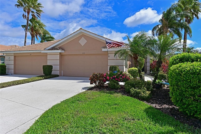 view of front of property with concrete driveway, an attached garage, a tiled roof, and stucco siding