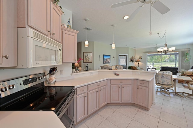 kitchen with electric stove, visible vents, white microwave, open floor plan, and a peninsula