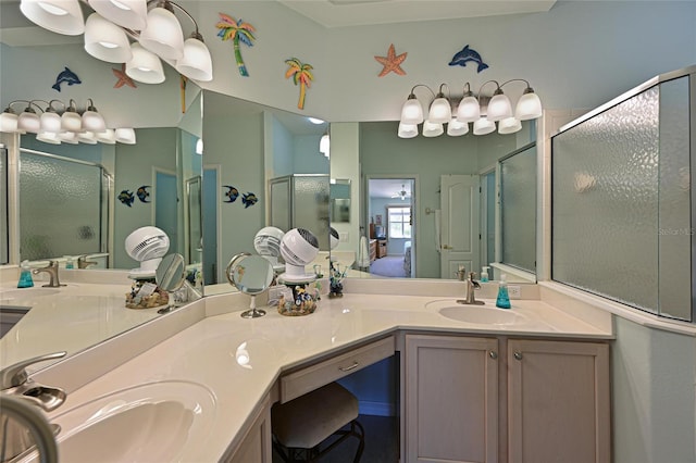 full bath featuring double vanity, a stall shower, and a sink