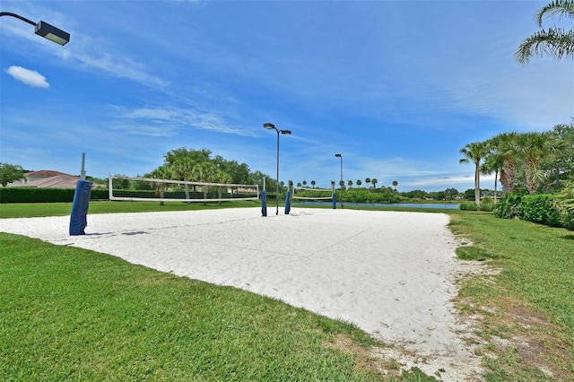 view of home's community featuring a lawn and volleyball court