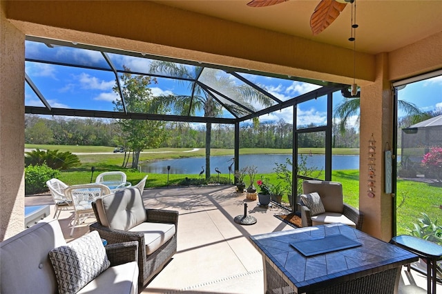 view of patio / terrace with glass enclosure, ceiling fan, a water view, outdoor lounge area, and outdoor dining space