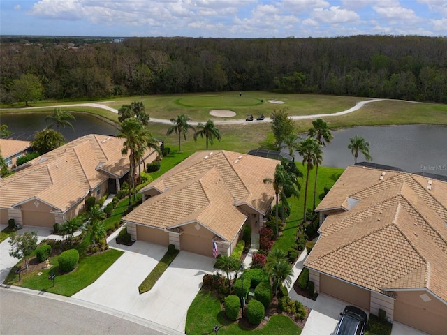 birds eye view of property featuring a water view and a view of trees