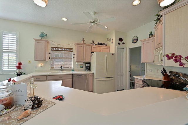 kitchen featuring recessed lighting, stainless steel appliances, a sink, a ceiling fan, and light countertops