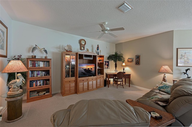 living room with baseboards, visible vents, ceiling fan, carpet, and a textured ceiling