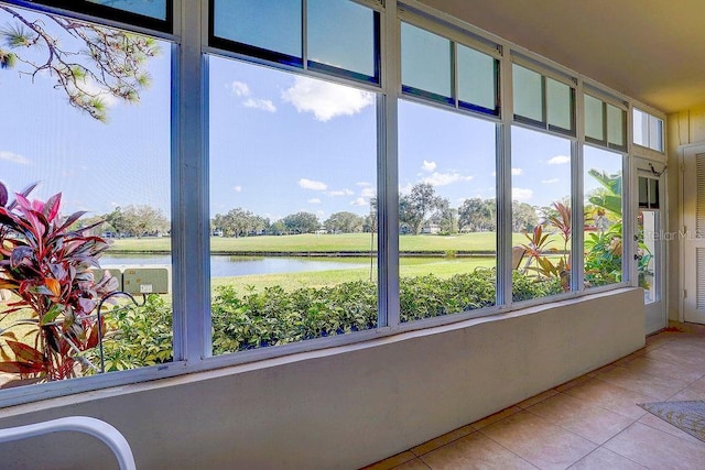 unfurnished sunroom with a water view