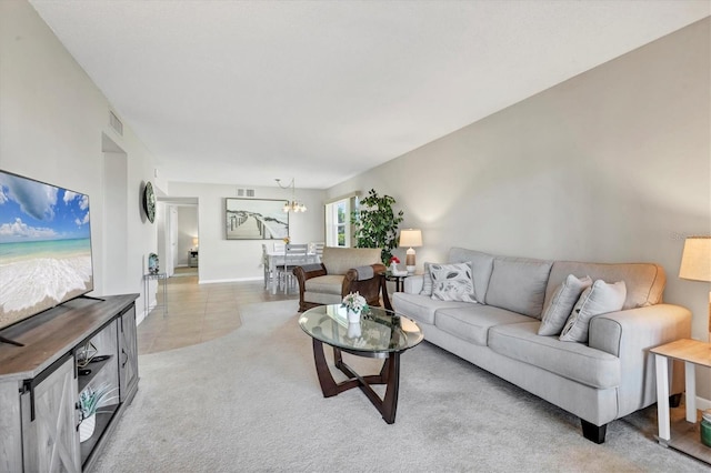 living room with light carpet, visible vents, and an inviting chandelier