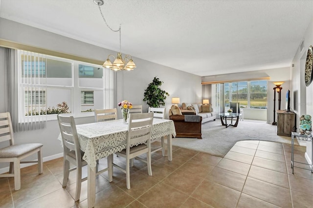 dining area featuring light tile patterned floors, visible vents, light colored carpet, a textured ceiling, and a chandelier