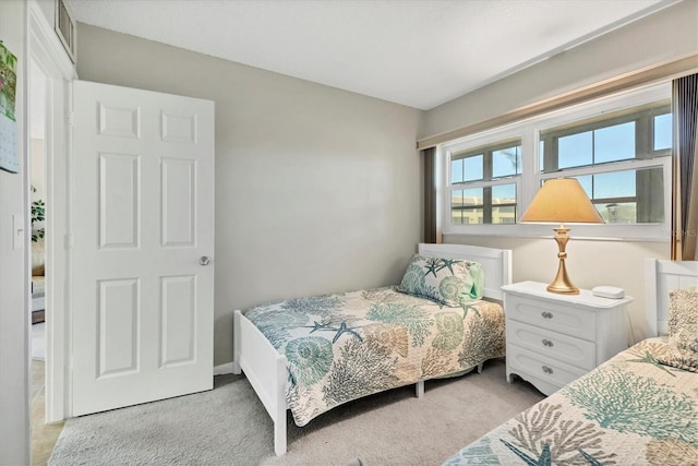 bedroom featuring light carpet and visible vents