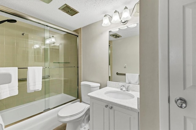 bathroom featuring visible vents, bath / shower combo with glass door, toilet, a textured ceiling, and vanity