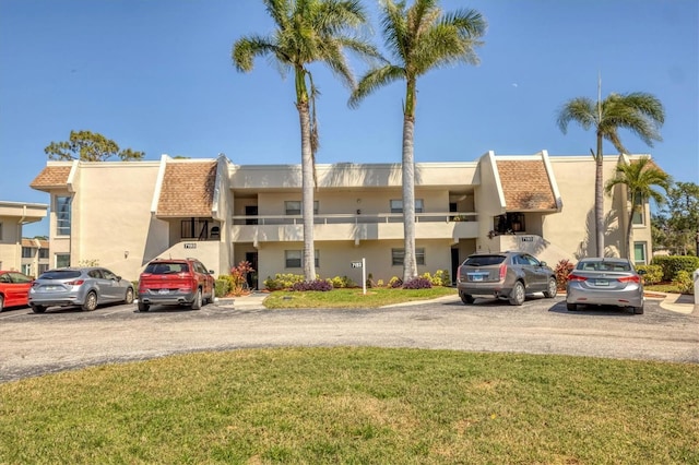 view of property with uncovered parking