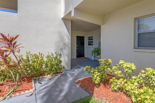 property entrance with stucco siding