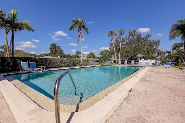 community pool featuring a patio area and fence