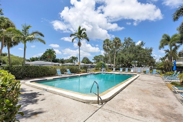 community pool featuring a patio area and fence