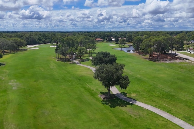 aerial view with golf course view and a water view