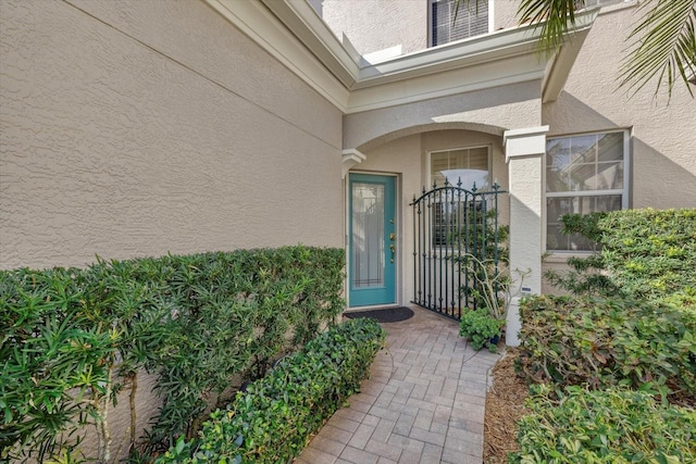 entrance to property featuring stucco siding