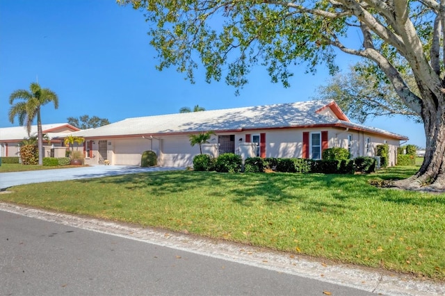 ranch-style home featuring a garage, driveway, a front lawn, and stucco siding