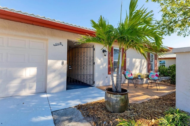 entrance to property featuring stucco siding