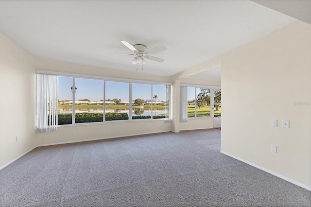 unfurnished room featuring carpet flooring, ceiling fan, and baseboards