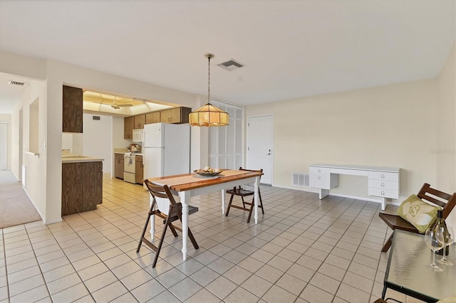 dining area with light tile patterned floors and visible vents