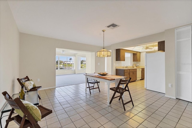 dining room featuring light tile patterned flooring, visible vents, and baseboards