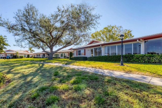 ranch-style home featuring a front yard