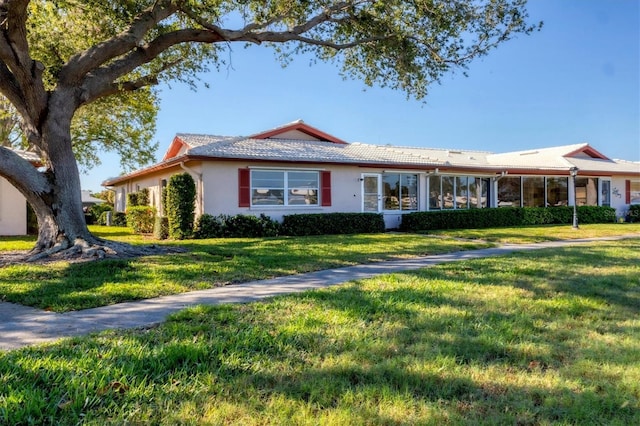 single story home with a front yard and stucco siding