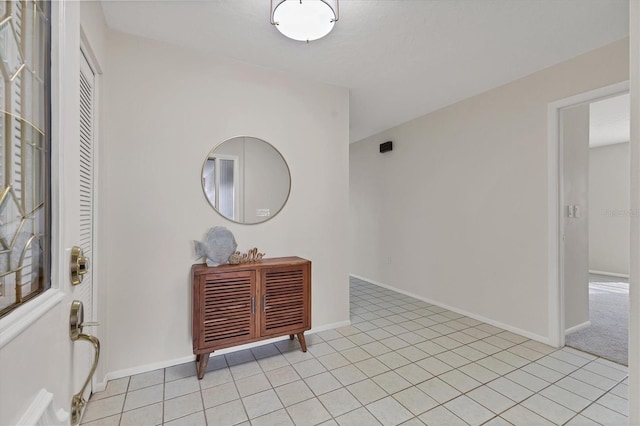 entrance foyer featuring light tile patterned floors and baseboards